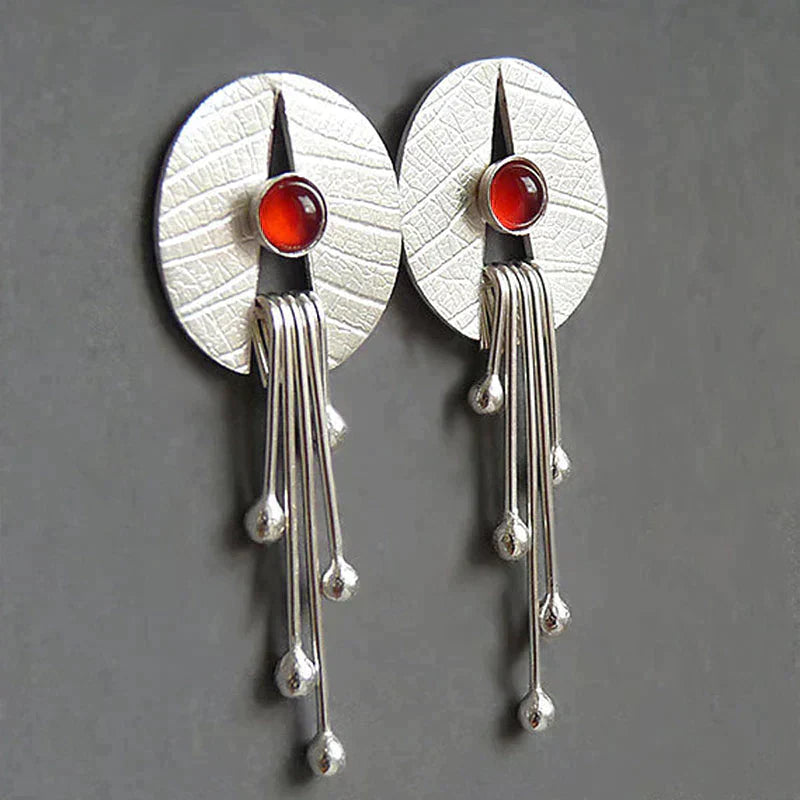Dangling earrings with hollow red stone