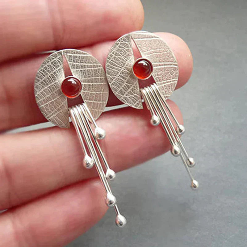 Dangling earrings with hollow red stone