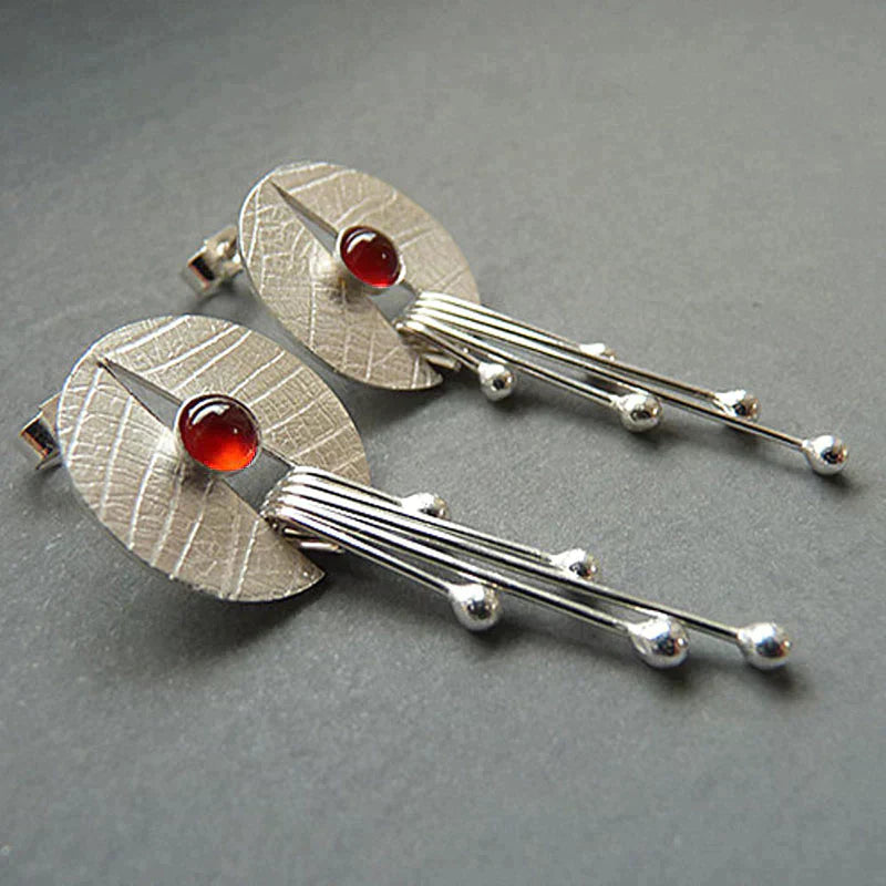 Dangling earrings with hollow red stone